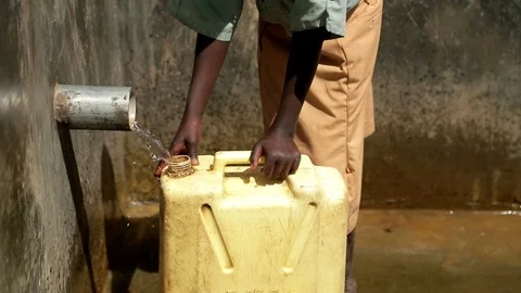 African Children fetching dirty drinking water using bottles to fill sour water Stock Footage 88015059