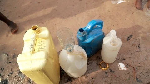 African Children fetching dirty drinking water using bottles to fill sour water Stock Footage 88015482