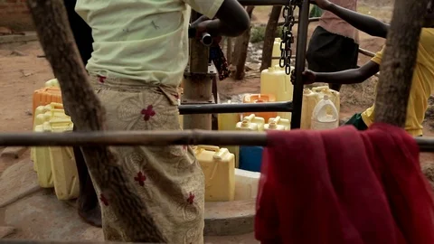 African Children fetching dirty drinking water using bottles to fill sour water Stock Footage 88016079