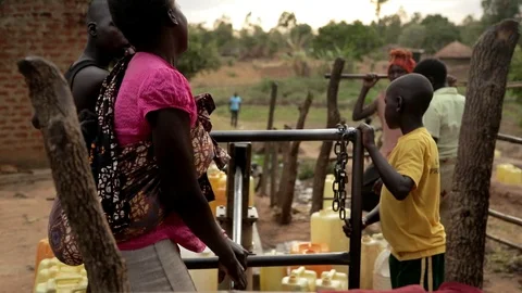 African Children fetching dirty drinking water using bottles to fill sour water Stock Footage 88016151