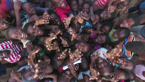 African children smiling and playing with drone - Top View Stock Footage