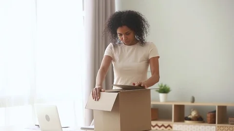 African client of postal delivery services opens box feels dissatisfied Vidéo 118693018