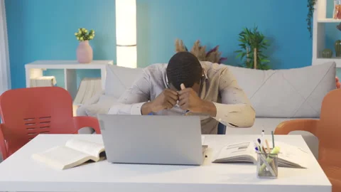 African college student dancing while studying at home. 動画素材 228803257