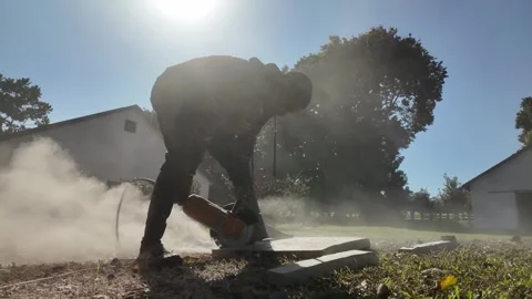 African Construction Site, Stone Grinder Slow Motion Dust Tracking Right to Left Video stock 337735243