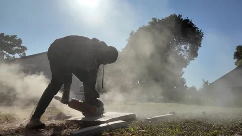 African Construction Site, Stone Grinder Slow Motion Dust Tracking Left to Right Vídeo Stock 337735249