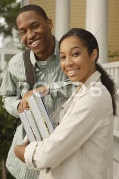 African couple carrying books and backpack Stock Photos