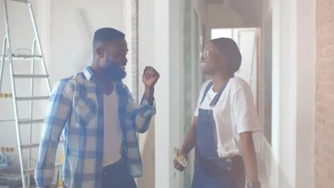 African couple dancing doing home repair and having fun Stock Footage 142217244