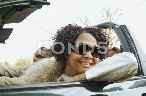 African couple driving in convertible car Stock Photos
