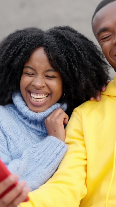 African couple having fun using mobile in the street Stock-Footage 262959278