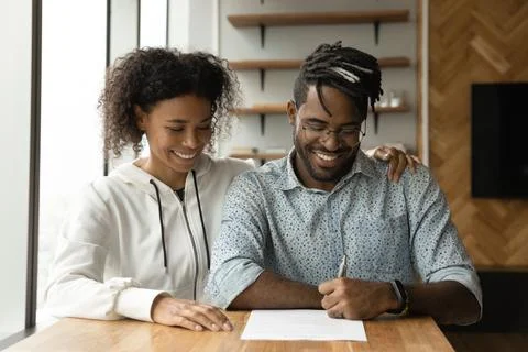 African couple make deal signing rent contract or loan agreement Stock Photos