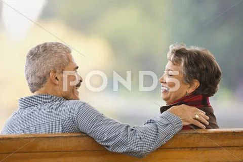 African couple sitting on bench Stock Photos
