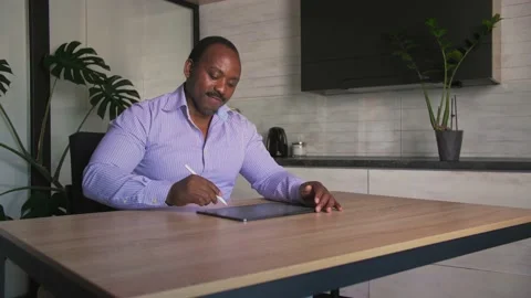 African creative man working with smart tablet to design and drawing. Stock Footage 201291627
