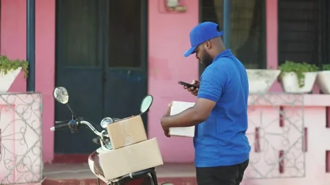 African Delivery Courier Man from Local Postal Shipping Service. Stock Footage 345522903
