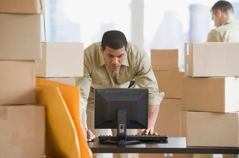 African delivery man looking at computer 写真素材