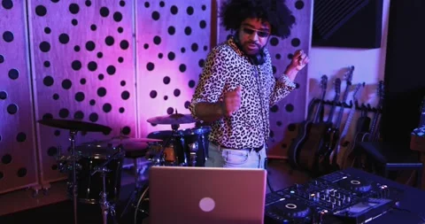 African dj man dancing while mixing new album inside boutique recording studio Видео 153404303