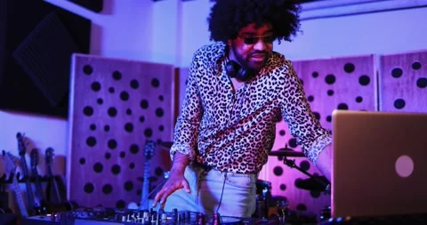 African dj man dancing while mixing new album inside boutique recording studio Stock Footage 153404333