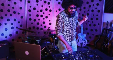 African dj man dancing while mixing new album inside boutique recording studio Stock Footage 153404336