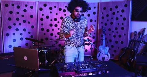 African dj man dancing while mixing music inside recording studio Vidéo 153404395