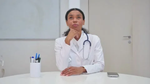 African Doctor Brainstorming while sitting in Clinic 動画素材 310065666