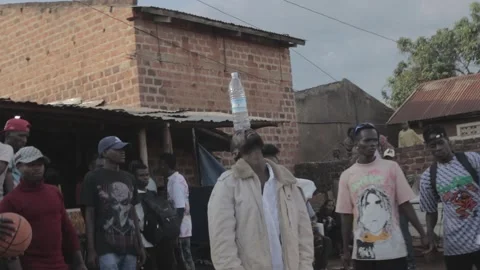 African drunk man playing with bottle Stock Footage 248634534