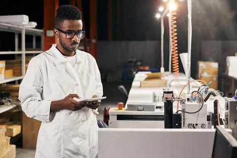 African engineer with tablet at factory Stock-Fotos