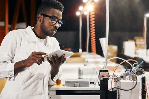 African engineer with tablet at factory Foto stock