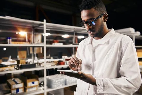 African engineer working with tablet at factory Stock-Fotos