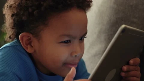 African ethnicity kid boy using digital tablet Stock Footage 170033908