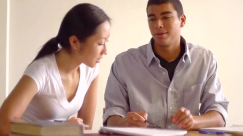 African Ethnicity Male Student Explaining Concept to Asian Female Student Stock Footage 6530694