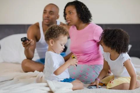 African family watching television and playing Stock Photos