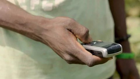 African farmer using old style mobile phone, 4k Stock Footage 90067797
