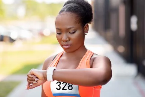 African female marathon runner with smart watch Stock Photos