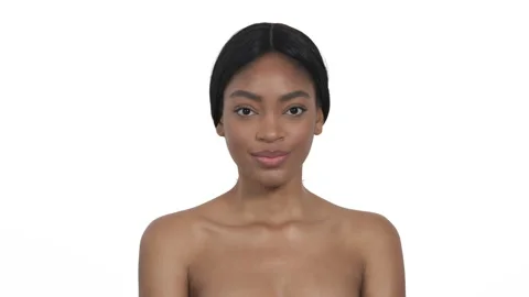 African female model posing at camera, moving her shoulders, touching decollete 스톡 동영상 131395615