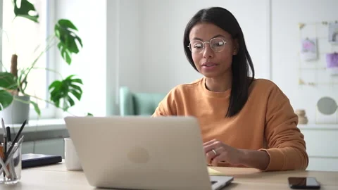 African female speaker interview talking through video camera in front of laptop Stock-Footage 147653504