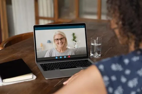 African female student having virtual meeting with old lady tutor Stock Photos