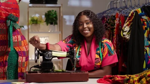 African female tailor creating unique garments in her workspace Stock Footage 346788160