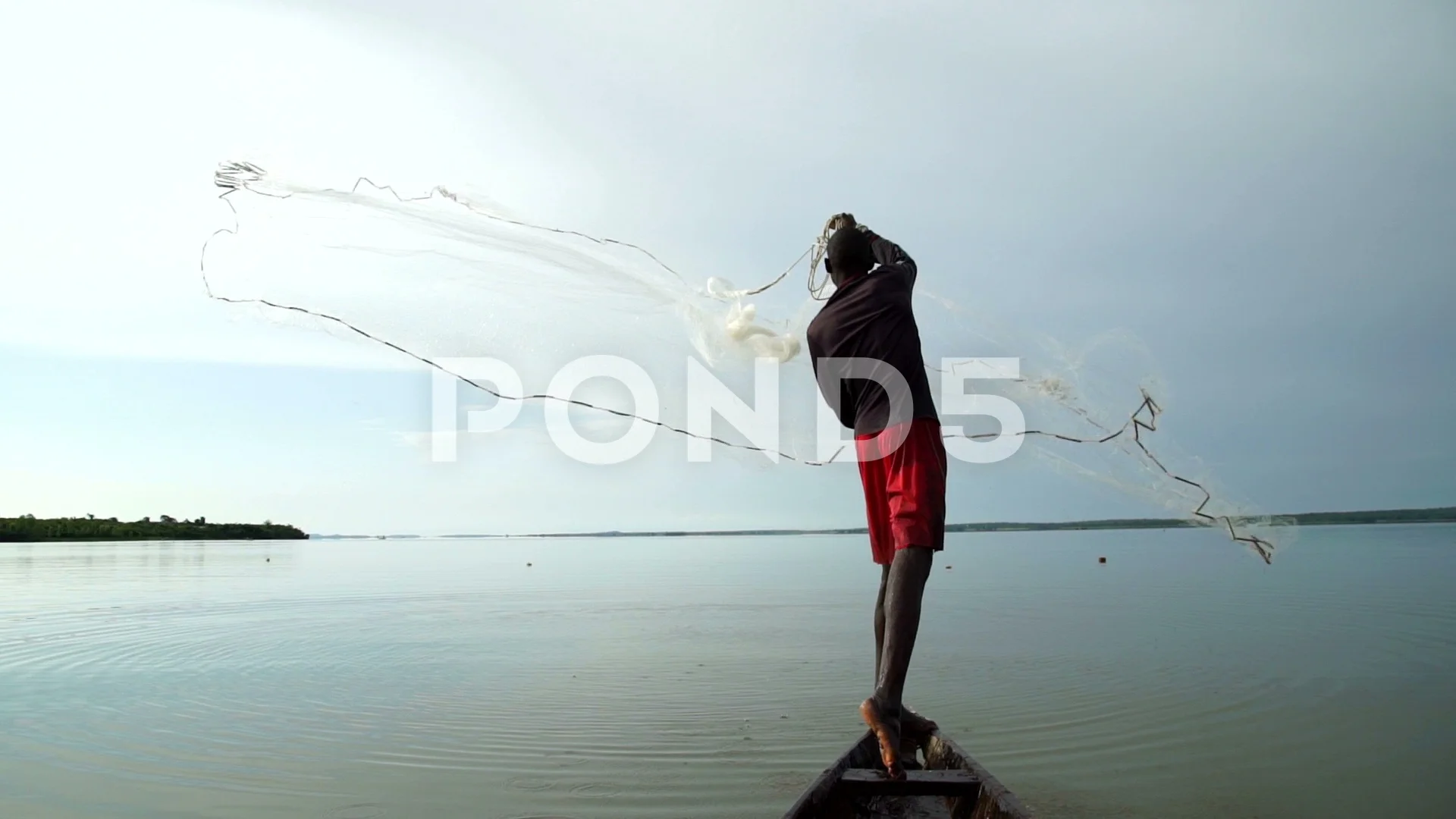 An African fisherman casts with skill a , Stock Video