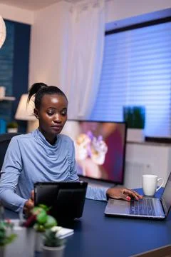 African freelancer using tablet pc working from home Foto stock