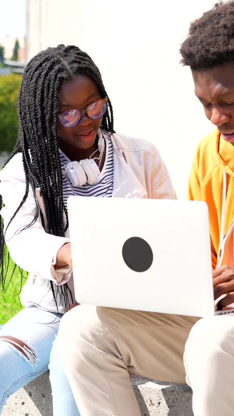 African friends using laptop studying online outside the campus Stock Footage 283066226
