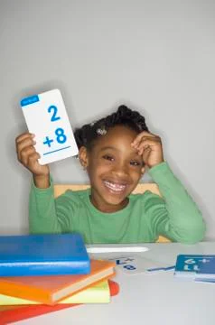 African girl holding addition flash cards Stock Photos