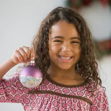 African girl holding Christmas ornament Stock Photos