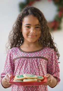 African girl holding plate of cookies Stock Photos