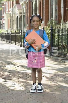 African girl holding school books Stock Photos