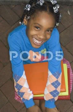 African girl holding school books Stock-Fotos