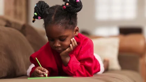 African Girl Lying on Couch Using Tablet for Homework and Online Learning Video stock 346224498