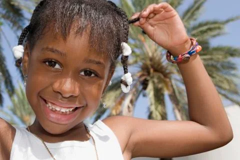 African girl pulling on braid Stock Photos