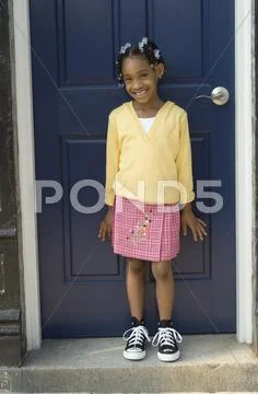 African girl standing in front of door Stock Photos