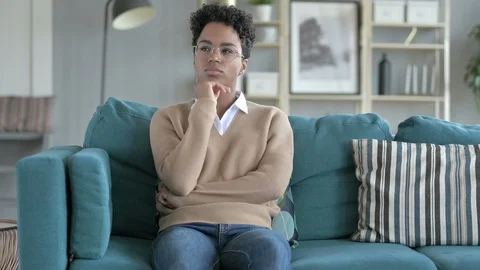 African Girl Thinking while Sitting on Couch Stock Footage 114791000