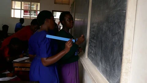 African Girls are practicing, solving mathematics questions on the blackboard Stock Footage 85125269