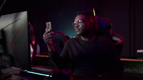 An african guy talks on a video link with his friends in a computer club Stock Footage 152800283